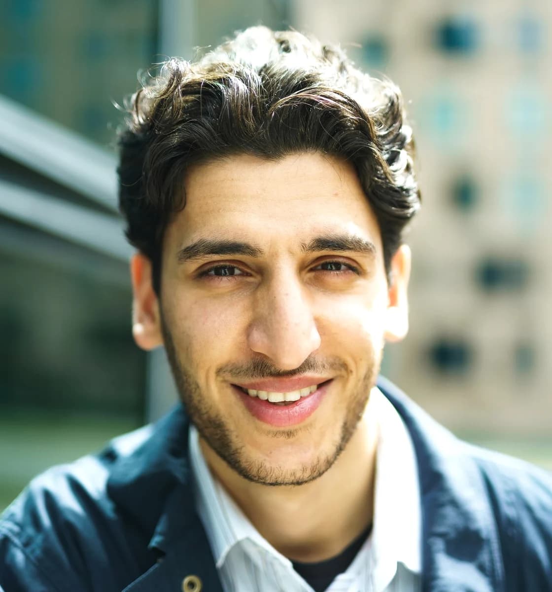 Alex, a fictional demonstration profile, in a warm urban setting